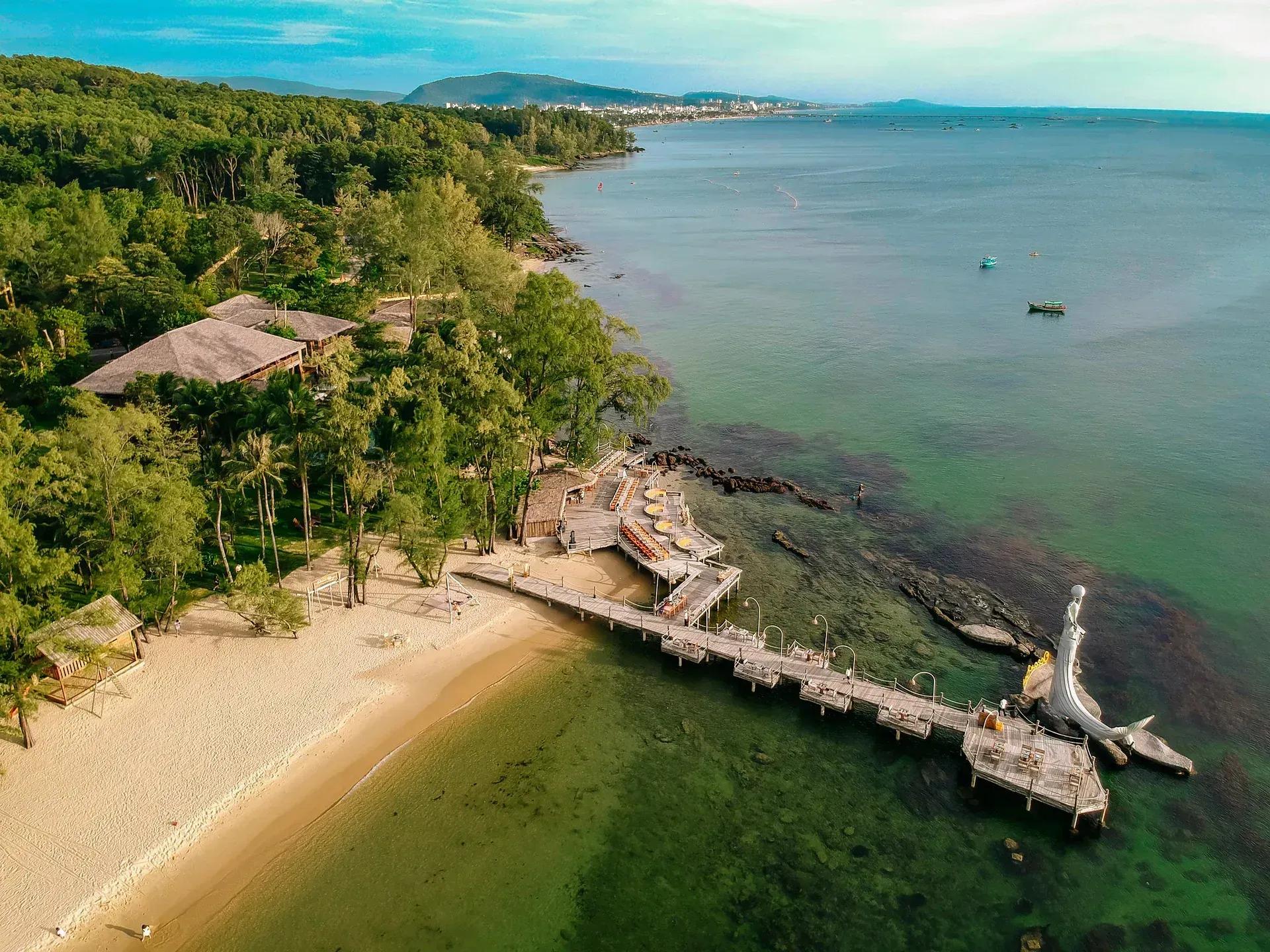 Ong Lang Beach featuring a wooden pier and sculpture overlooking the vivid blue ocean.