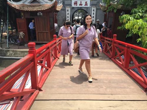 A group of visitors dressed in modest clothing gathers together, ensuring they adhere to the dress code while exploring a cultural or religious site